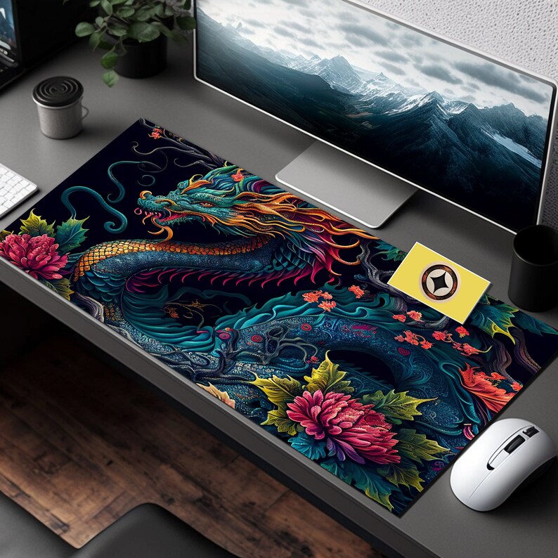 May include: A colorful mousepad with a detailed illustration of a blue and green dragon with gold accents, surrounded by pink and purple flowers. The dragon is curled around a tree branch with a dark background.