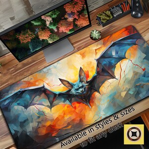 May include: A colorful abstract painting of a bat with blue wings against a yellow, orange, and red background. The text "Available in styles & sizes to fit any desk" is at the bottom of the image.
