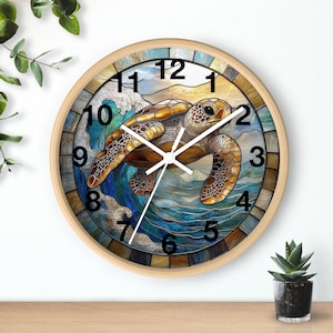 May include: A round wall clock with a stained glass design featuring a sea turtle swimming in a wave. The clock face has Roman numeral hour markers and black hands.