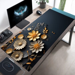 May include: A black desk mat with a floral design featuring gold and white paper flowers. The flowers are arranged in a cluster and have a 3D effect.