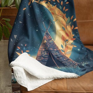 May include: A cozy throw blanket featuring a whimsical design. The blanket showcases a teepee with intricate patterns set against a night sky with a crescent moon and foliage. The blanket has a soft, white sherpa backing.