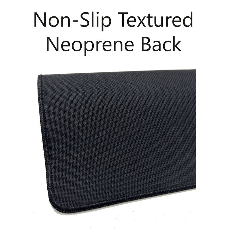 May include: Close-up of the black, textured, non-slip neoprene backing of a mouse pad. The backing is designed to prevent the mouse pad from sliding on a desk.