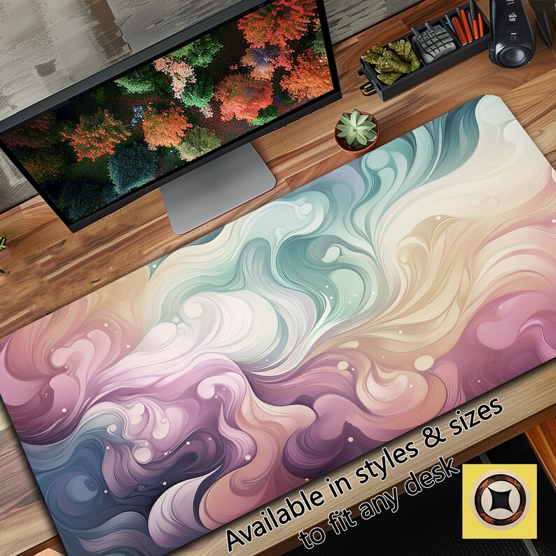 May include: Abstract swirl design desk mat with a colorful pattern of pink, purple, blue, and yellow. The mat is available in different styles and sizes to fit any desk. The text "Available in styles & sizes to fit any desk" is printed on the mat.