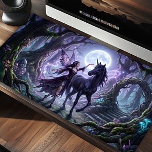 May include: A desk mat with a fantasy scene of a fairy and a black unicorn in a moonlit forest. The artwork uses a purple and blue colour scheme, with detailed illustrations of trees, mushrooms, and magical elements.