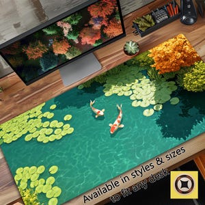 May include: A green and blue desk mat with a pond scene featuring two white and orange koi fish swimming among lily pads. The text "Available in styles & sizes to fit any desk" is printed on the mat.