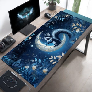 May include: A blue and white mousepad with a cartoon squirrel sitting on a crescent moon. The background features a dark blue sky with white stars and a pattern of blue and gold leaves.