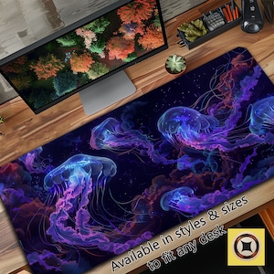 May include: A dark blue desk mat with a glowing jellyfish design. The jellyfish are translucent and have a purple and blue glow. The background is a dark blue with a starry sky effect. The text "Available in styles & sizes to fit any desk" is at the bottom of the mat.