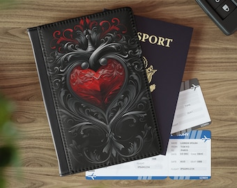 May include: A black passport holder with a red heart and ornate silver design. The holder is lying on top of a blue passport and two airline boarding passes.