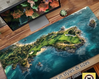 May include: A blue and green aerial view of a golf course on a tropical island. The golf course is surrounded by blue water and lush green vegetation. The text "Available in styles & sizes to fit any desk" is at the bottom of the image.
