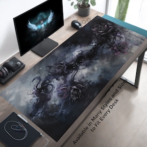 May include: A dark blue and gray abstract design with black flowers and vines. The design is on a desk mat with the text "Available in Many Styles and Sizes to Fit Every Desk".