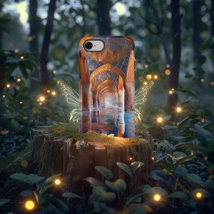 May include: A phone case with a colorful image of an ornate archway reflecting in a pool of water. The case is surrounded by a glowing green fairy wing design and is sitting on a tree stump in a forest setting.