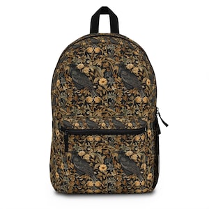 May include: Black backpack with a floral pattern featuring black birds and yellow flowers. The backpack has a zippered front pocket.