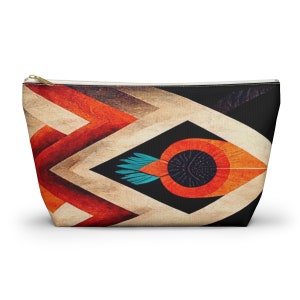 May include: A geometric patterned makeup bag with a large orange eye design in the center. The eye has a black pupil and a blue feather detail.