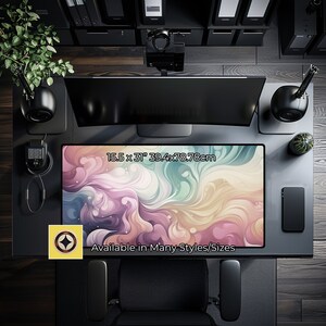 May include: A colorful abstract design desk mat with swirls of pink, purple, blue, and yellow. The mat measures 15.5 x 31 inches (39.4 x 78.8 cm) and the text "Available in Many Styles/Sizes" is printed on the mat.