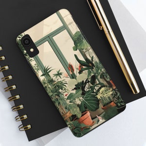 May include: A phone case featuring a colourful illustration of plants in a greenhouse setting. The case depicts a variety of green plants, red flowers, and a window with a view of the outdoors.