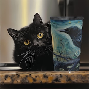 May include: A black cat with yellow eyes sits on a counter next to a blue and green travel mug with a black bird design. The mug has a starry night sky background.