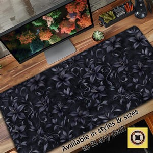 May include: Black and white floral design desk mat with the text "Available in styles & sizes to fit any desk".
