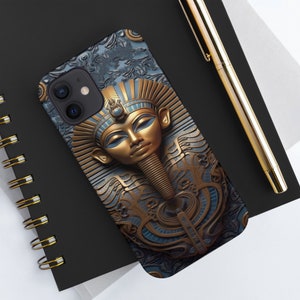 May include: A phone case with a gold and blue design featuring a pharaoh's face. The design is intricate and detailed, with a focus on the pharaoh's face and head.