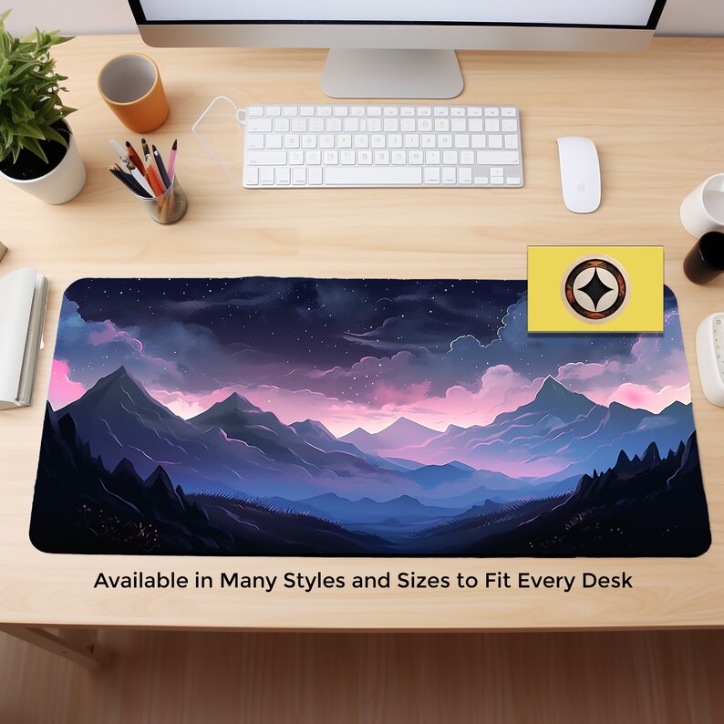May include: A purple and blue mountain range with pink clouds and a starry night sky. The mousepad features a stylized landscape design. "Available in Many Styles and Sizes to Fit Every Desk" is printed at the bottom of the mousepad.