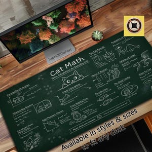 May include: A dark green rectangular desk mat featuring white line art and text titled Cat Math: Feline Calculations for Everyday Life. The design includes various mathematical formulas, geometric diagrams, and cat illustrations.