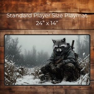 May include: A standard size playmat featuring a raccoon wearing a hooded jacket and holding a sword, sitting in a snowy forest. The playmat is 24 inches by 14 inches.