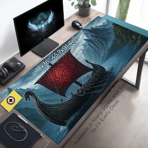 May include: A desk mat with a Viking ship design, measuring 18x36 inches (45.7x91.4cm). The mat features a red sail with a geometric pattern, a black ship, and a blue ocean scene. Text on the mat reads "Available in Many Styles and Sizes to Fit Every Desk."