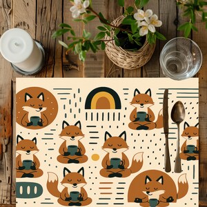 May include: A beige placemat with a repeating pattern of cartoon foxes holding mugs. The foxes are brown with black accents. A rainbow and other geometric shapes are also on the placemat. A knife and spoon are on the right.