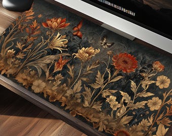May include: A dark gray mousepad with a floral design featuring gold and red flowers, butterflies, and leaves.