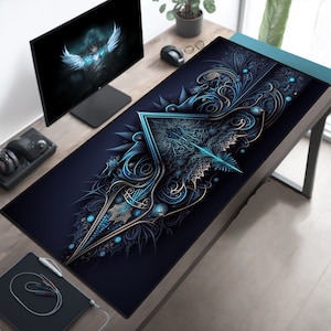 May include: A blue and gold patterned mousepad with a large, intricate design. The design features a central triangle with swirling patterns and a blue and gold color scheme.