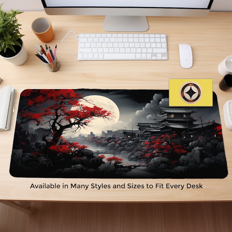 May include: A black and red mousepad with a Japanese-inspired design featuring a full moon, a red-leafed tree, and a traditional Japanese building. The text "Available in Many Styles and Sizes to Fit Every Desk" is at the bottom of the mousepad.