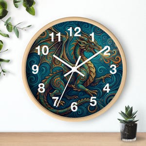 May include: A round wall clock with a wooden frame. The clock face features a detailed illustration of a dragon in teal, gold, and brown hues. White hands indicate the time against white numerals.