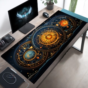 May include: A black and gold mouse mat with a celestial design featuring a sun, moon, and stars. The design is intricate and detailed, with a vintage aesthetic.