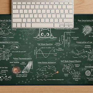May include: A dark green mousepad with a chalkboard design, featuring cat-themed physics equations and diagrams in white. A silver keyboard rests at the top. The mousepad includes text like "Conservation of Cat Energy."
