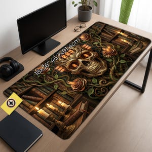 May include: A decorative desk mat featuring a detailed skull design with roses and vines, set against a backdrop of bookshelves and candles. The mat measures 45.7cm x 91.4cm.