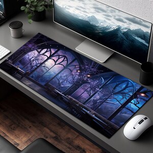 May include: A large, rectangular mousepad with a dark blue and purple background. The image features a large, intricate window with a view of a starry night sky and a forest. The window is framed by a dark, gothic-style archway.