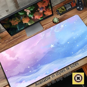 May include: A pink and blue desk mat with a watercolor sky design and white stars. The text "Available in styles & sizes to fit any desk" is printed on the mat.