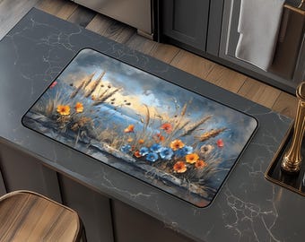 May include: A colourful floral design kitchen mat with blue, orange and yellow flowers on a blue and brown background. The mat features a seascape with a sunset in the background.