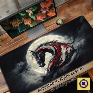 May include: A black and white horse with red accents stands in front of a full moon. The horse is stylised and appears to be made of metal. The background is dark and cloudy. The text "Available in styles & sizes to fit any desk" is at the bottom of the image.