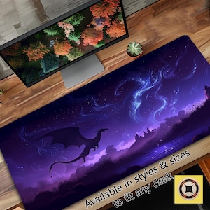 May include: A purple and black gaming mouse pad with a silhouette of a dragon flying over a fantasy landscape with a starry sky. The text "Available in styles & sizes to fit any desk" is at the bottom of the image.