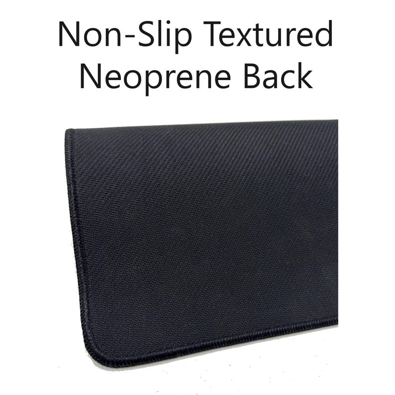 May include: Close-up of a black mousepad with a non-slip textured neoprene back. The mousepad has a dark color and a stitched edge. The text "Non-Slip Textured Neoprene Back" is displayed at the top of the image.