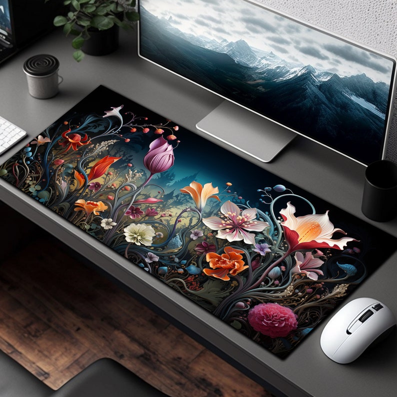 May include: A black and blue floral design mousepad with a dark background. The mousepad features a variety of flowers in shades of pink, red, orange, yellow, and purple. The flowers are surrounded by intricate vines and leaves.