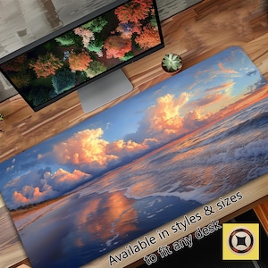 Puede incluir: Una alfombrilla de ratón de escritorio colorida con una imagen escénica de una playa al atardecer con nubes y olas. El texto "Available in styles & sizes to fit any desk" está en la parte inferior de la imagen.