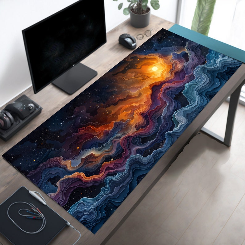 May include: A large, colorful mousepad with a galaxy-like design featuring swirling, layered clouds in shades of blue, purple, orange, and yellow against a dark blue background with white stars.