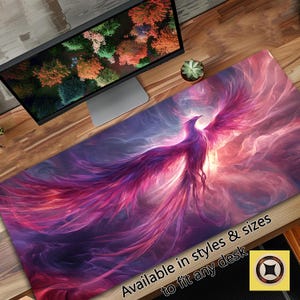 May include: A vibrant purple and pink phoenix with outstretched wings against a swirling, colourful background. The text "Available in styles & sizes to fit any desk" is at the bottom of the image.