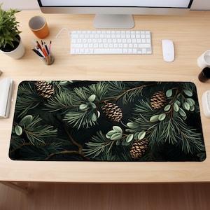 May include: A dark green mousepad with a pine branch design. The branches are decorated with brown pine cones and green leaves.