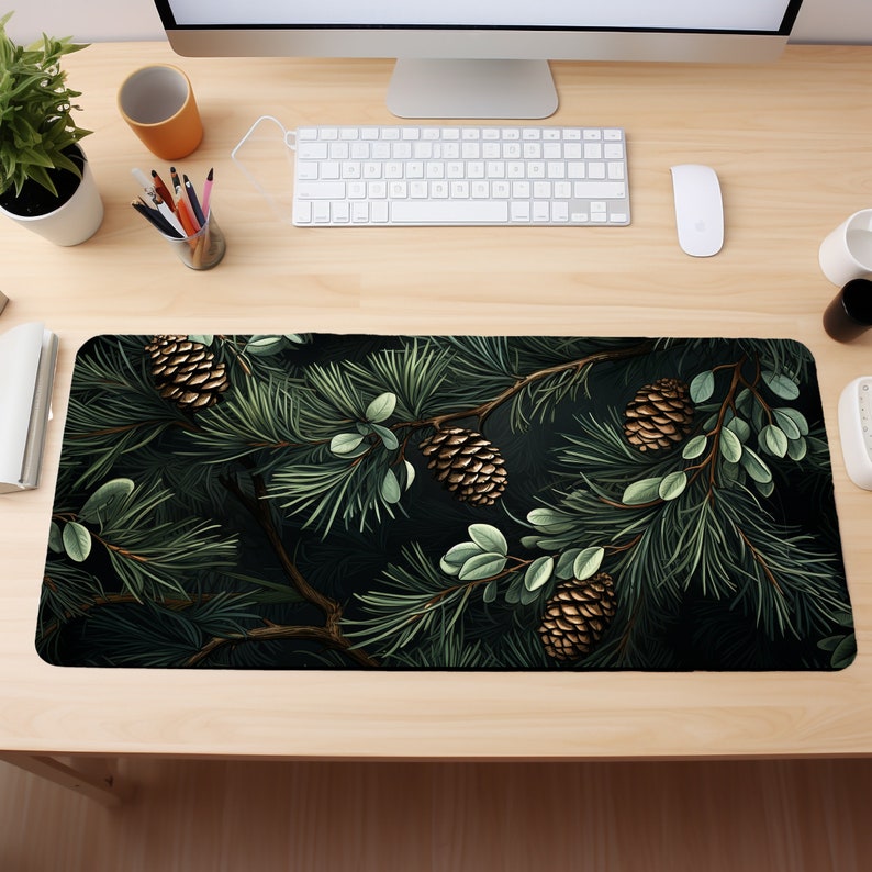 May include: A dark green mousepad with a pine branch design. The branches are decorated with brown pine cones and green leaves.