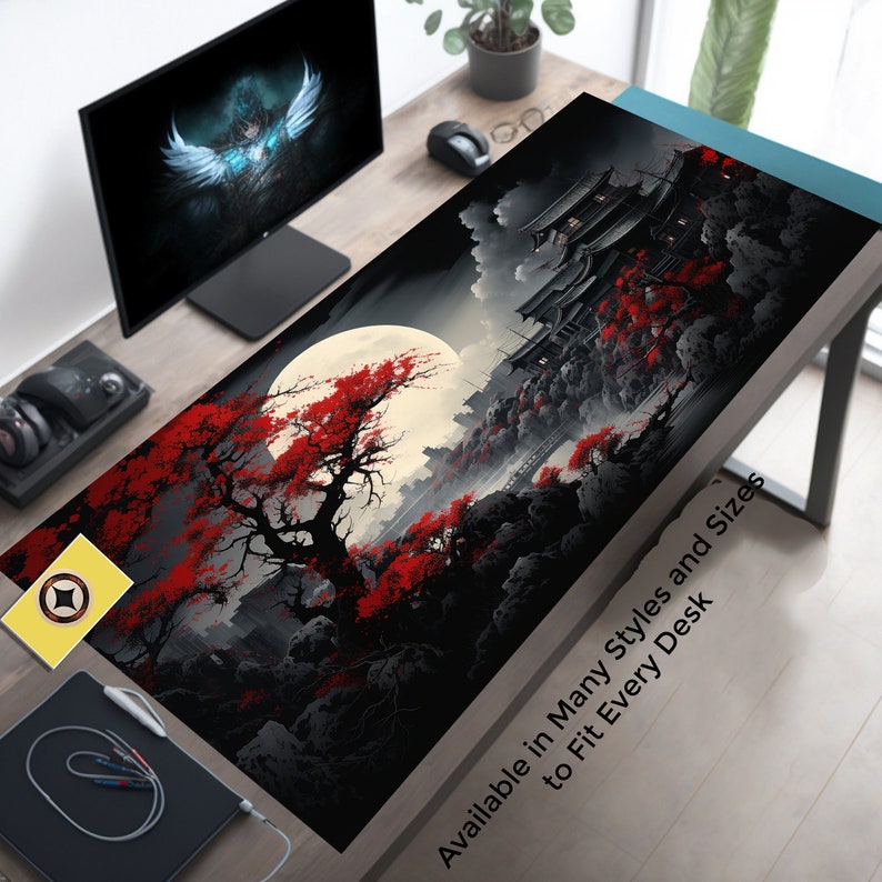 May include: Black and red Japanese-inspired design with a full moon and cherry blossoms. The design is printed on a black gaming mouse pad. The text "Available in Many Styles and Sizes to Fit Every Desk" is printed on the bottom right corner of the mouse pad.