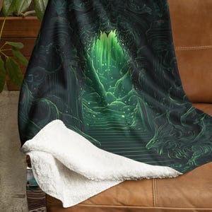 May include: A green and black fleece throw blanket with a fantasy-themed design featuring a stone archway leading to a green, glowing forest. The archway is adorned with intricate carvings and the forest is filled with glowing green light.