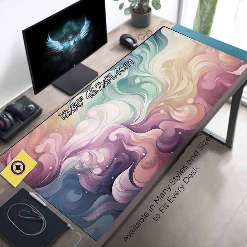 May include: A large, colorful abstract desk mat with swirling patterns in shades of pink, purple, blue, and yellow. The mat measures 18x36 inches (45.7x91.4 cm) and has the text "Available in Many Styles and Sizes to Fit Every Desk".