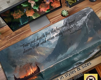 May include: A desk mat featuring a scenic landscape with a burning Viking ship sailing on a lake. The background includes mountains and a cloudy sky. The text "Fear not death for the hour of your doom is set and none may escape it." is written in black on the mat. The text "Norse Proverb" is written in smaller font below the quote. The mat is available in various styles and sizes to fit any desk.